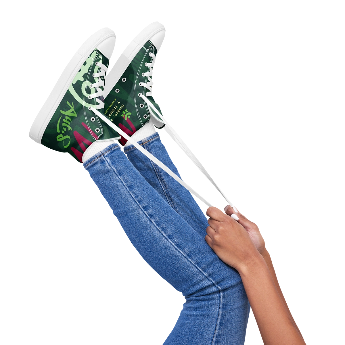 Primer plano de las manos de una modelo tensando los cordones blancos de las zapatillas de lona altas Caza-Morosos.